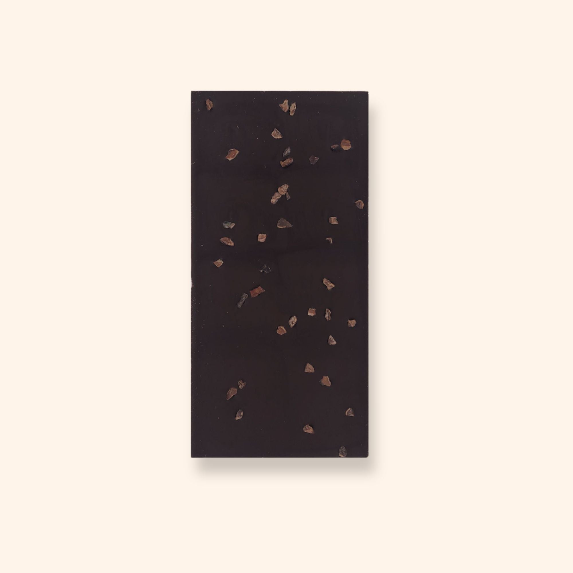 The back of a vegan dark chocolate bar by Harry Specters decorated with roasted cocoa nibs