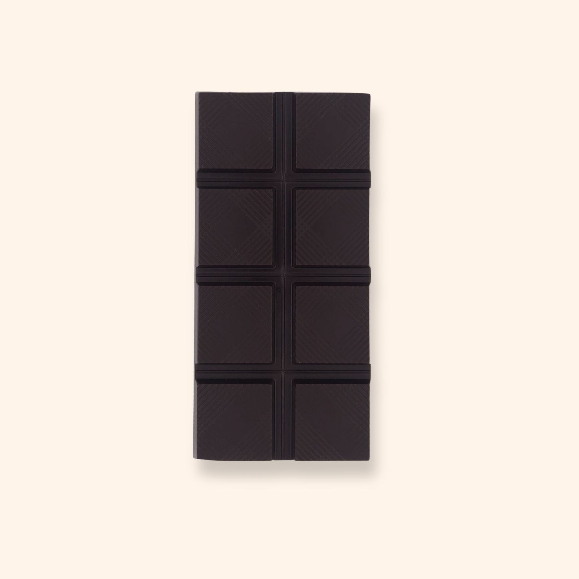 The front of a vegan dark chocolate bar by Harry Specters decorated with roasted cocoa nibs