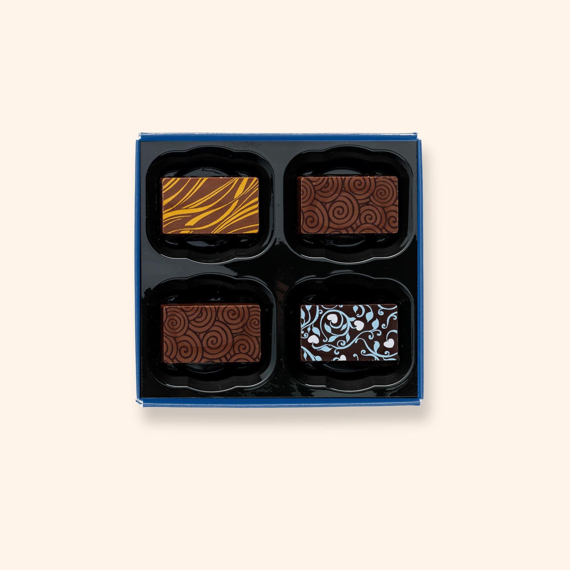 A box of 4 artisan chocolates colourfully decorated