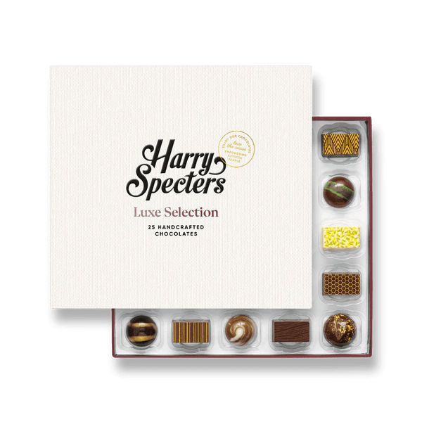 A box of 25 artisan chocolates partially covered by a box lid featuring the name Harry Specters