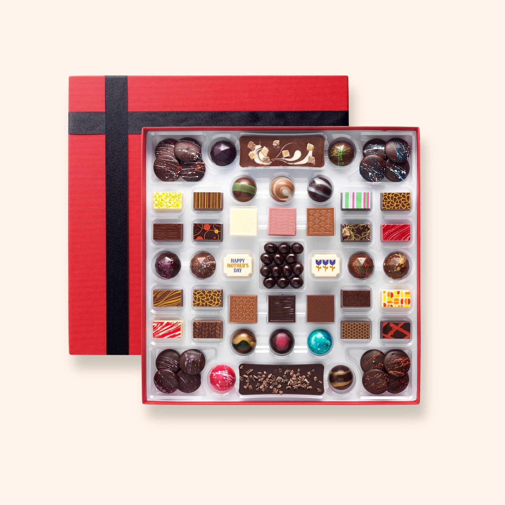 A chocolate box including buttons, bars, and coffee beans colourfully decorated and featuring two Mother's Day chocolates
