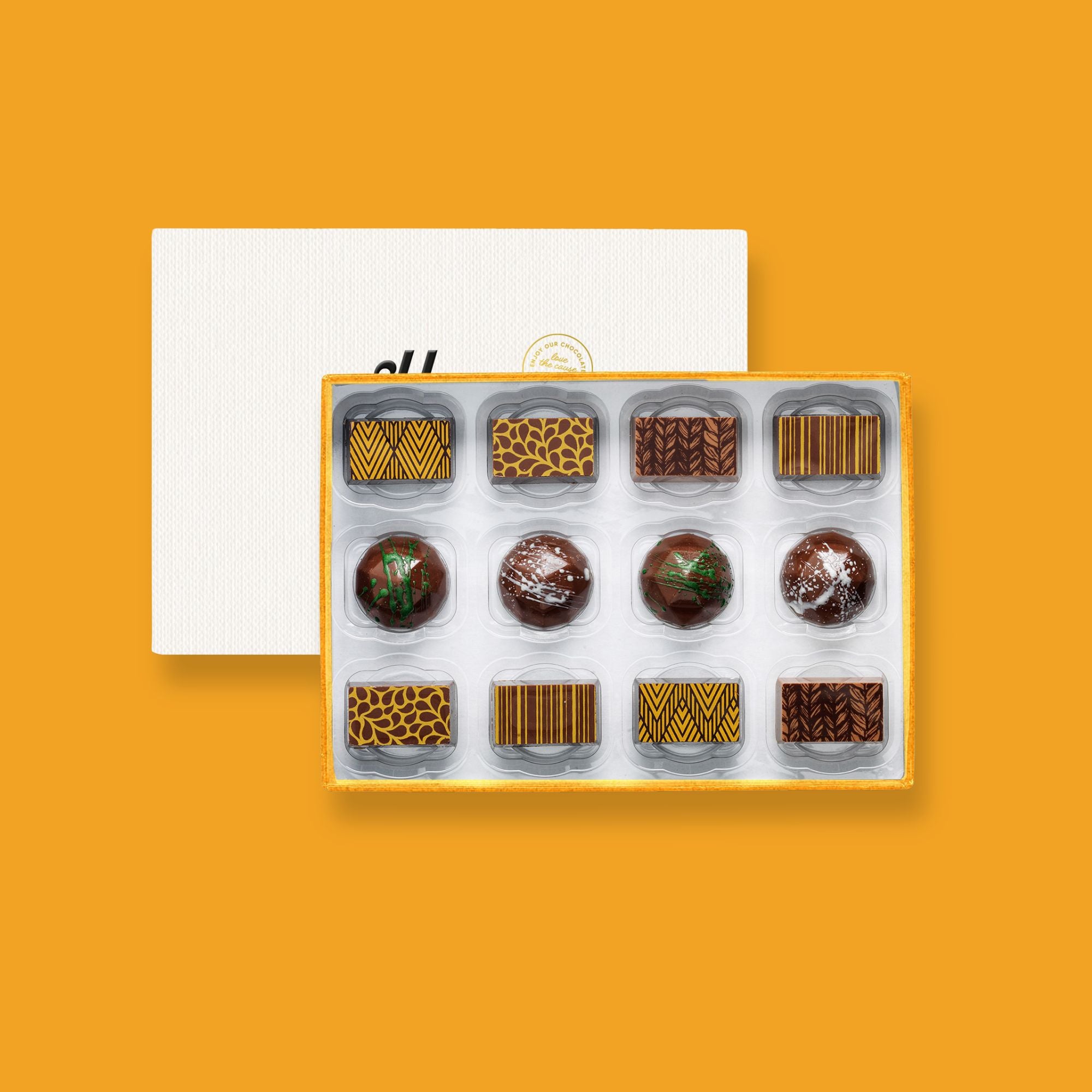 A box of 12 colourfully decorated artisan chocolates with nuts
