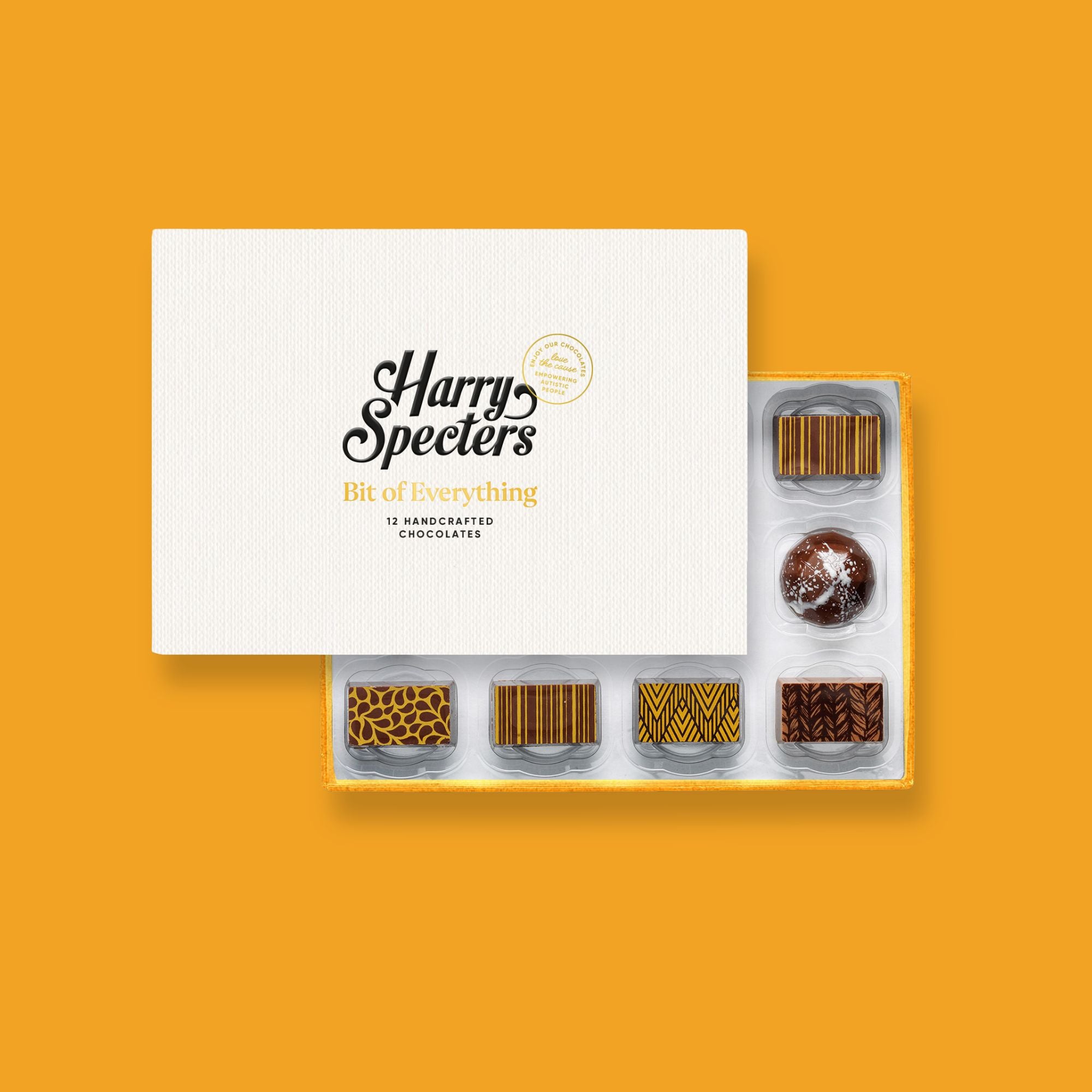 A box of 12 artisan chocolates with nuts partially covered by a box lid featuring the name Harry Specters