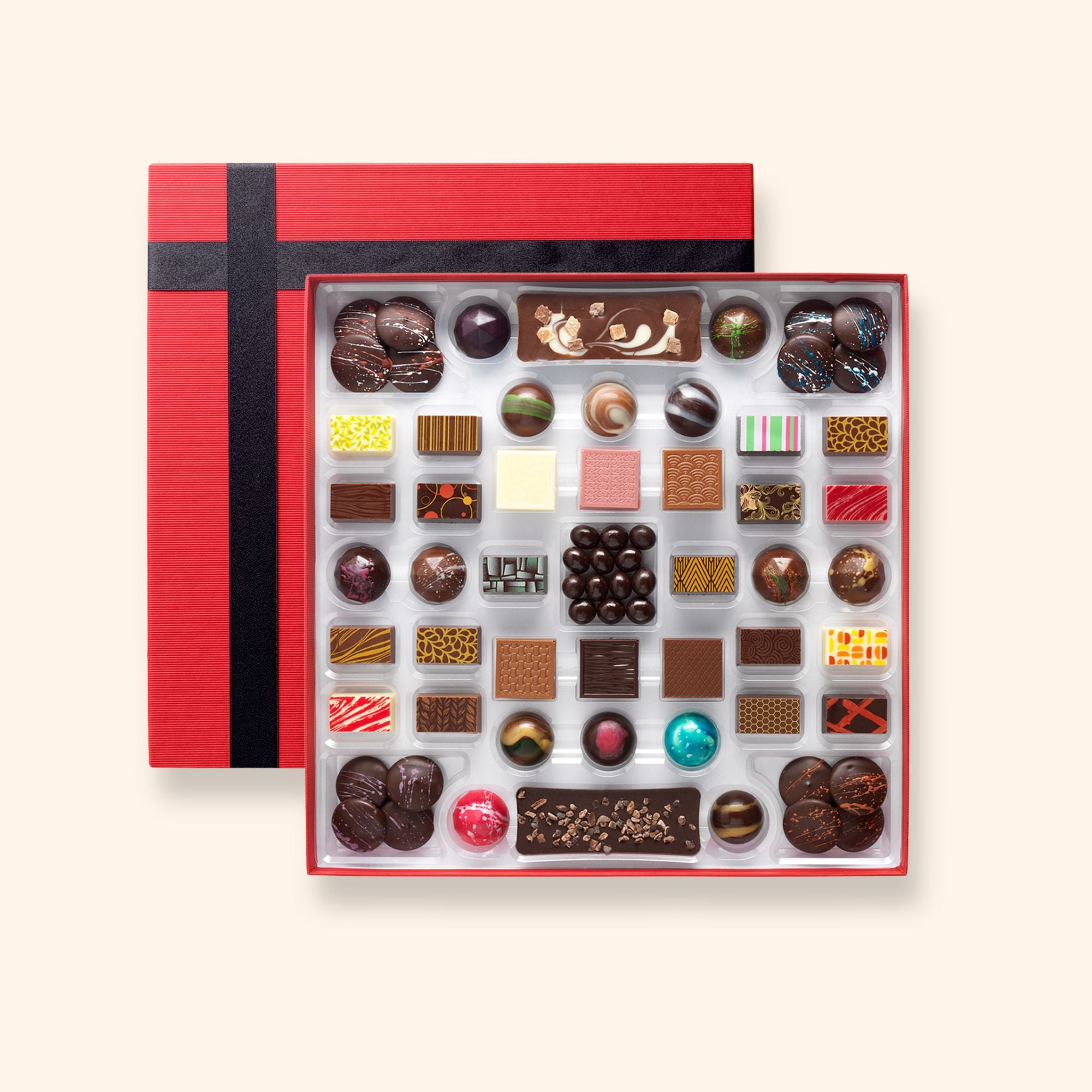 A box including chocolate buttons, bars, coffee beans and colourfully decorated chocolates