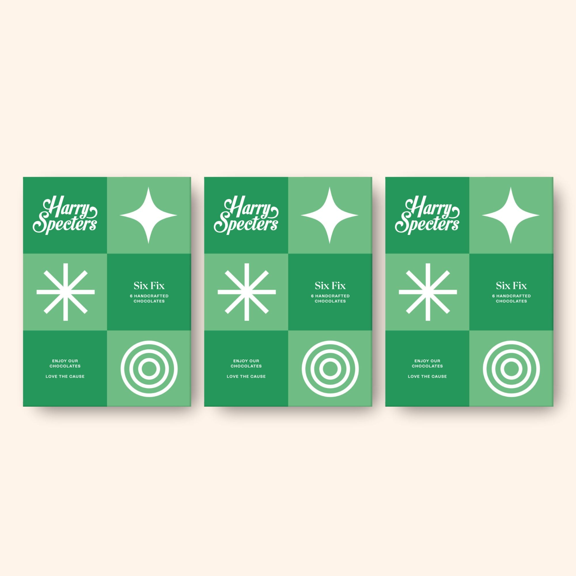 Three green premium chocolate boxes with white designs and text on a light beige background