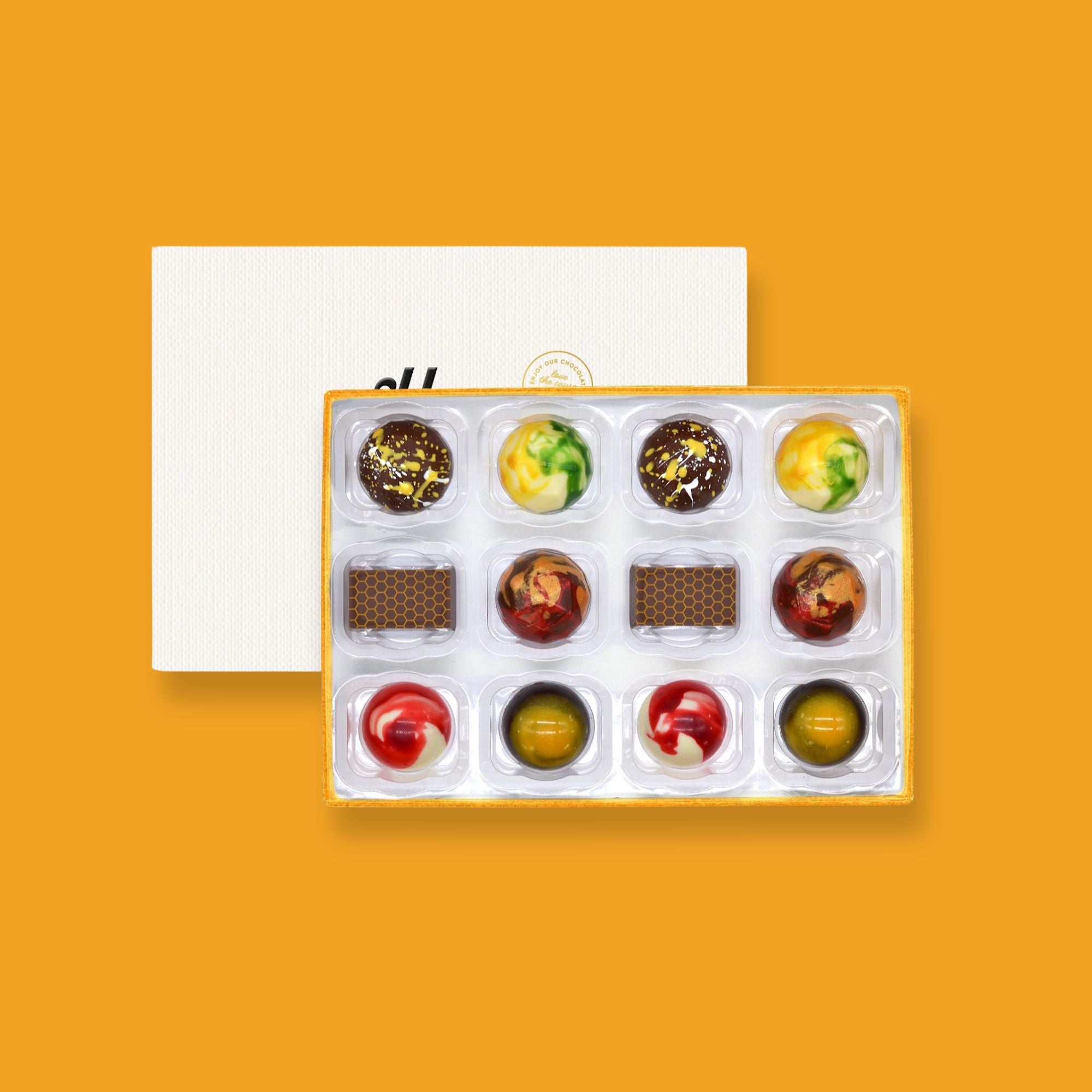 A box of 12 colourfully decorated artisan chocolates with summer flavours