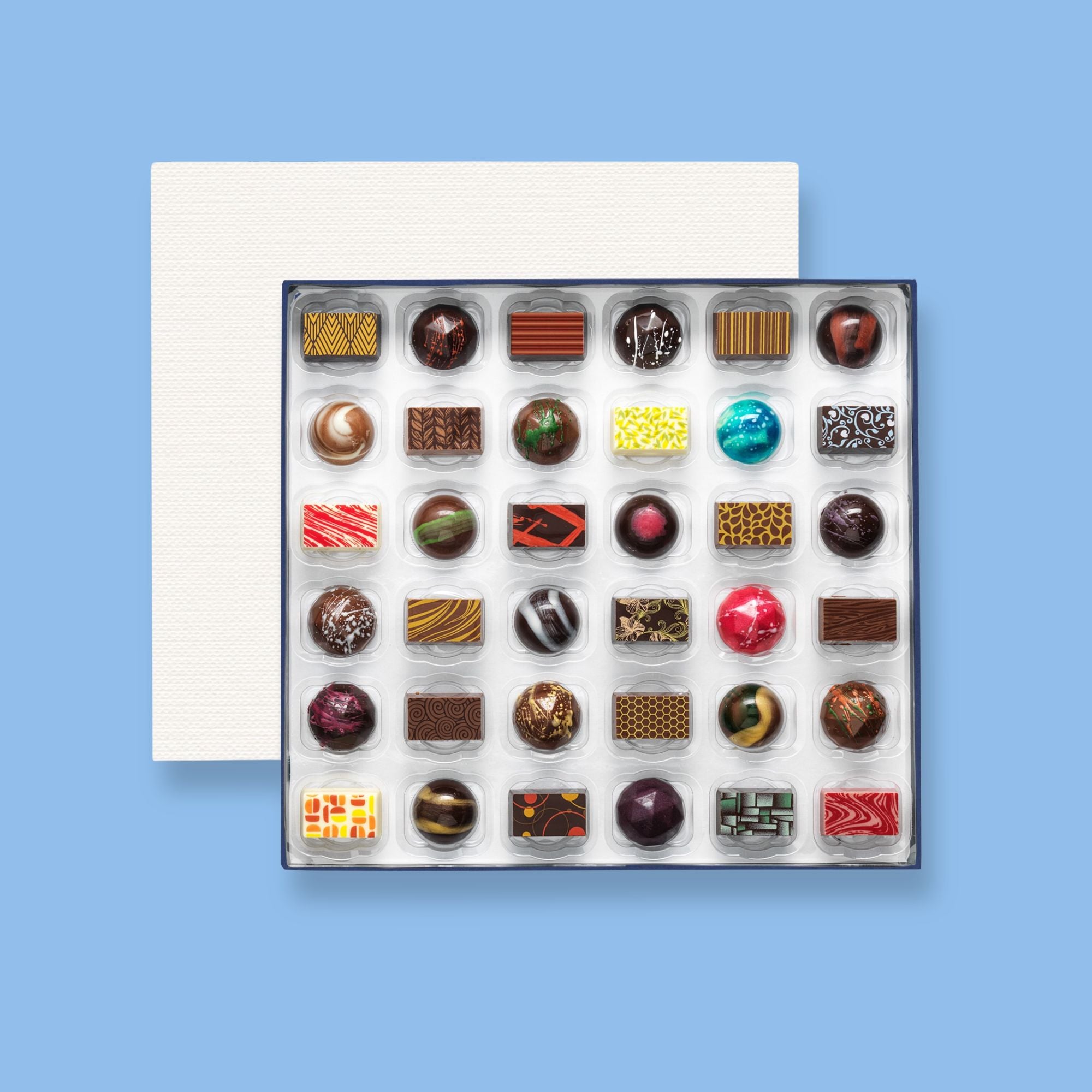 A box of 36  colourfully decorated artisan chocolates