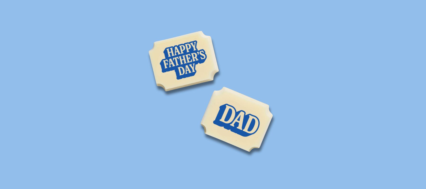 Two luxury white chocolates with a message that reads 'happy Father's Day Dad'