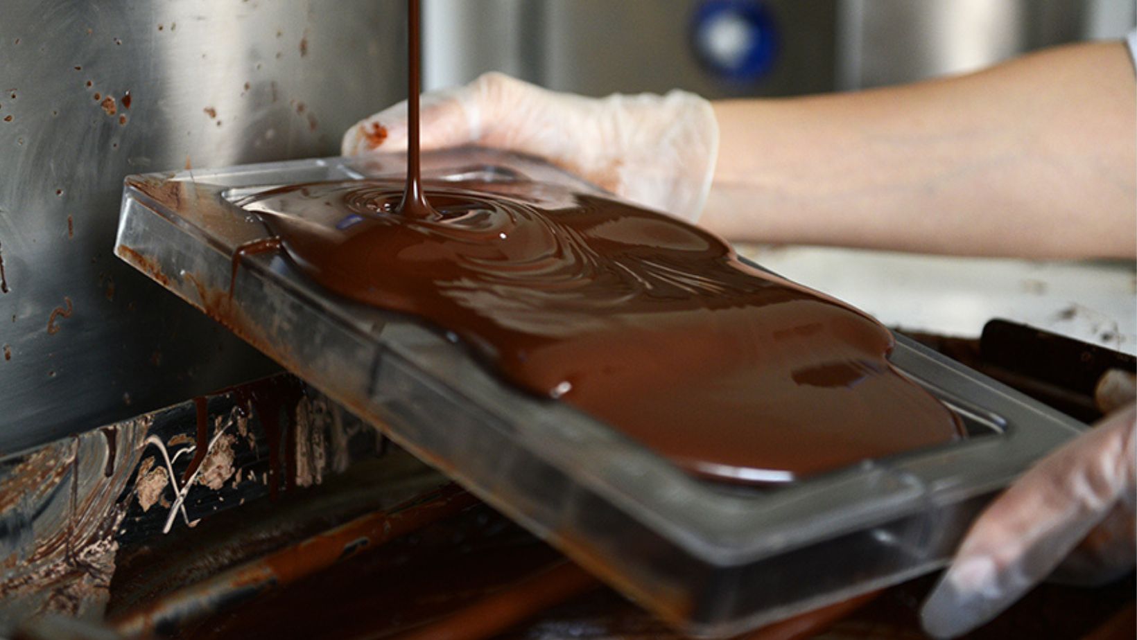 Melted dark chocolate being poured into a mould