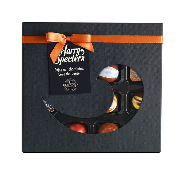 A box of 16 chocolates by Harry Specters in a cut out box with a bow for a chocolate subscription