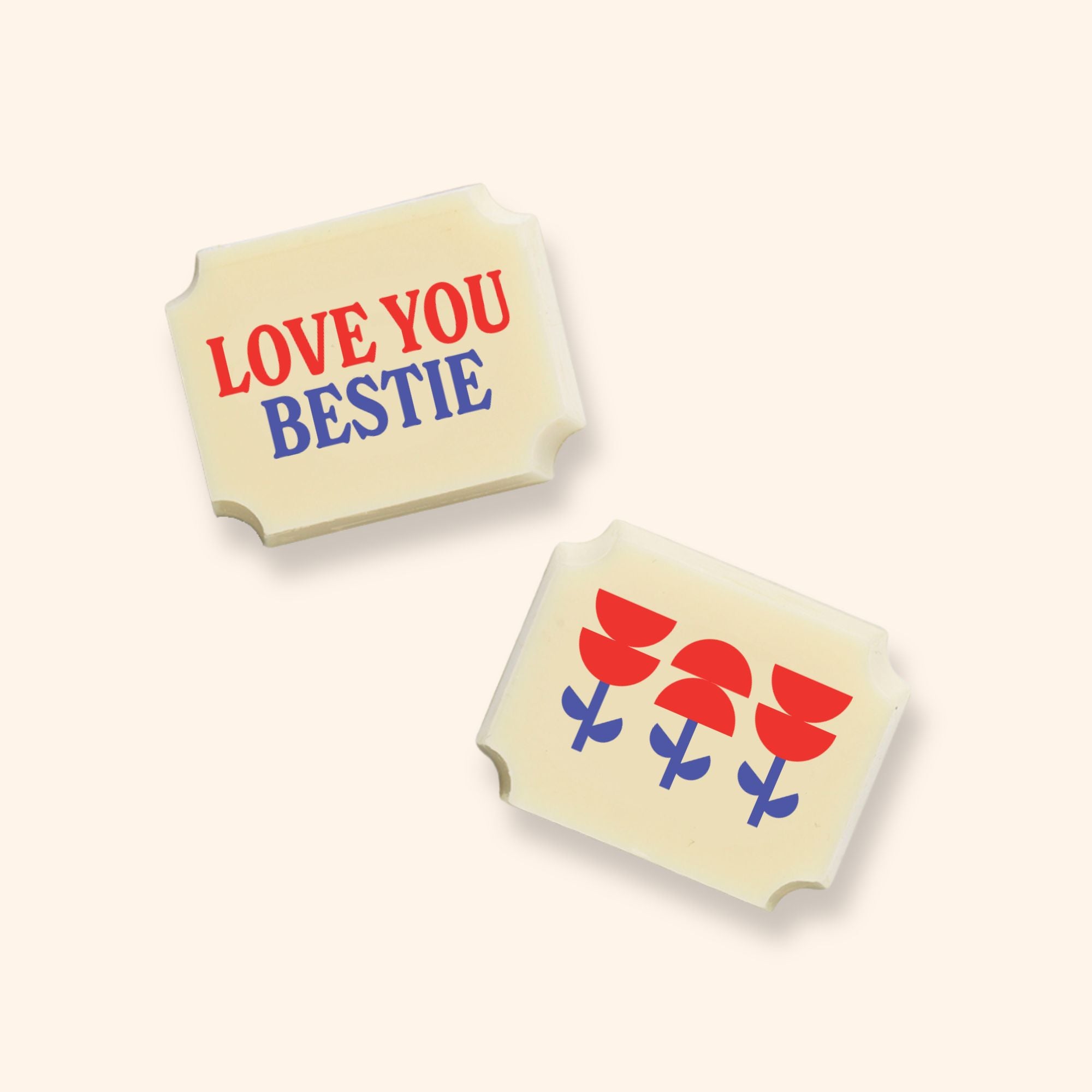 Two white rectangular chocolates with 'love you bestie' text and floral design on a white background