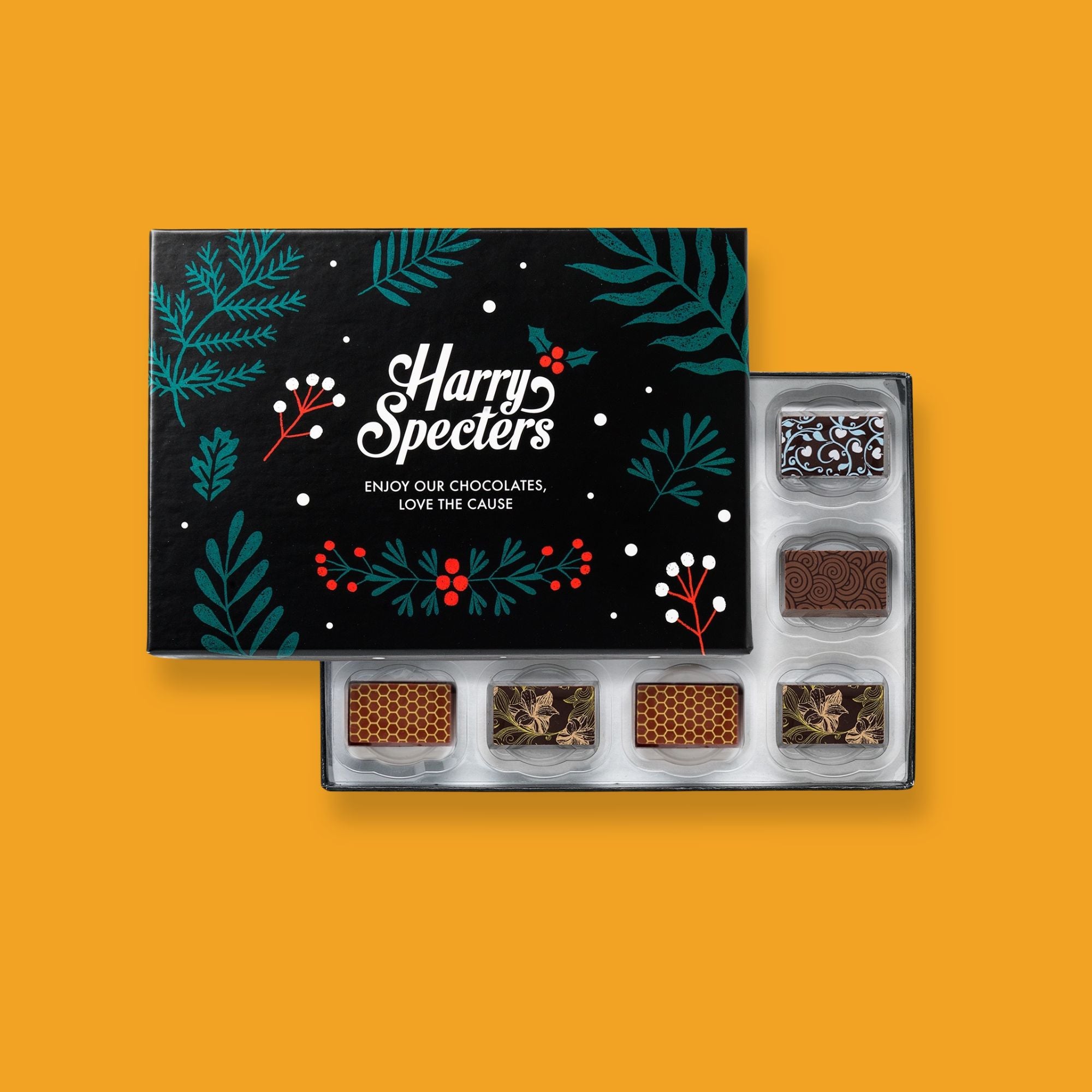 A Harry Specters Christmas sharing box of 12 colourfully decorated artisan chocolates partially covered by a lid