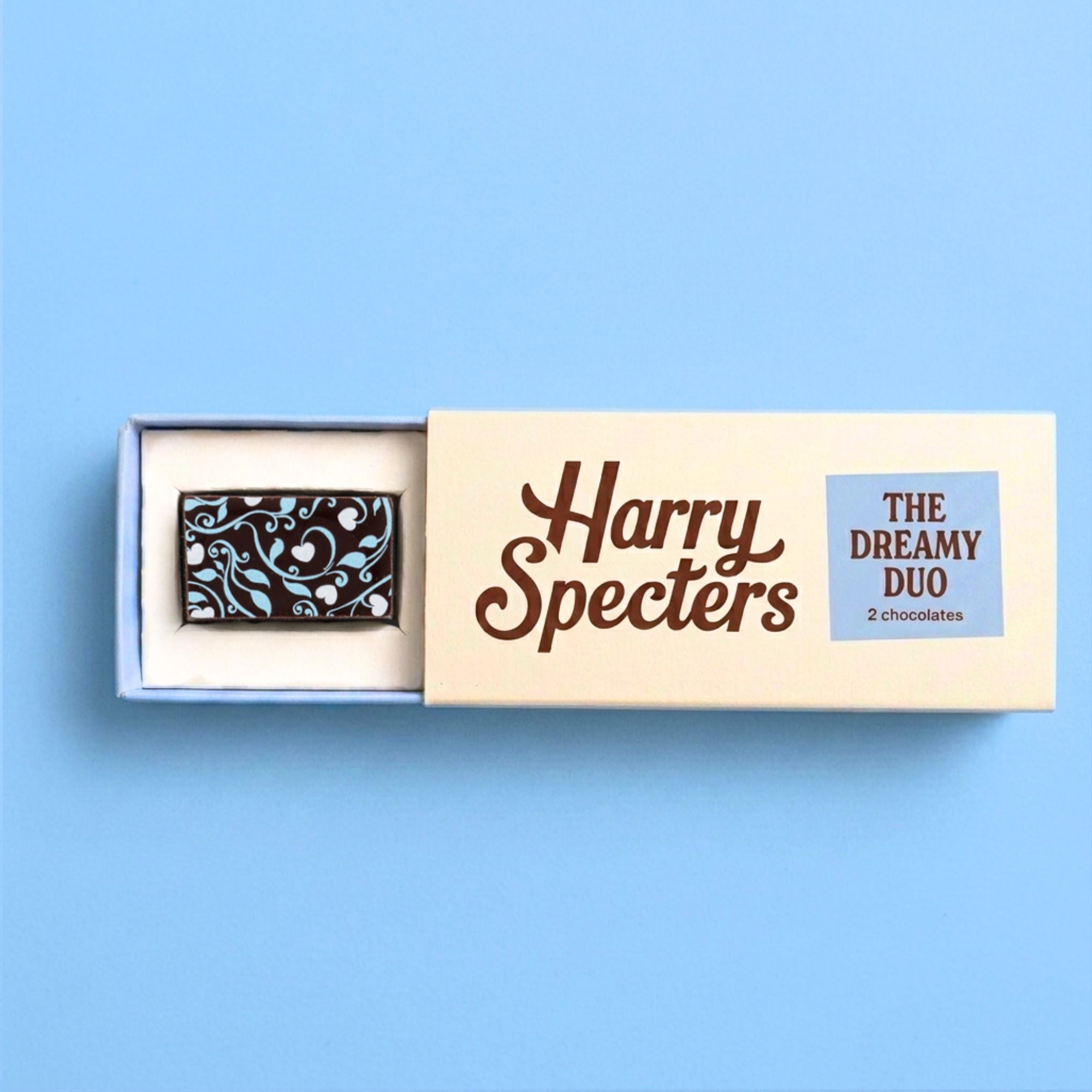 An artisan chocolate in a box labelled 'Harry Specters' on a blue background
