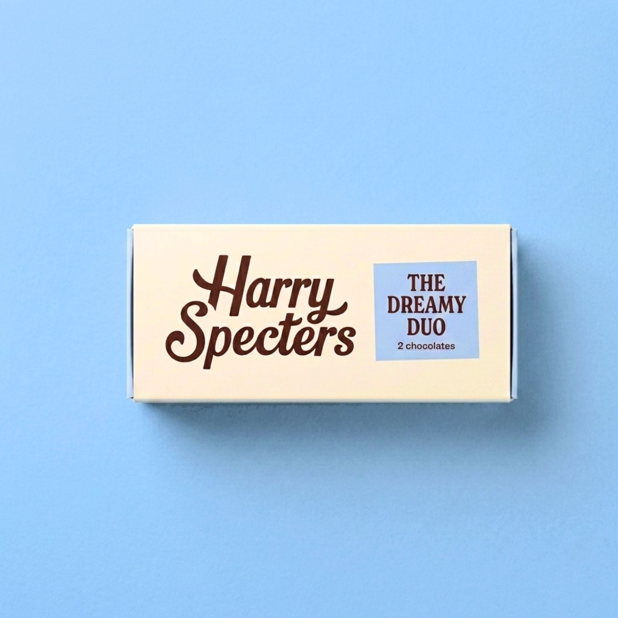 Small box of luxury chocolates from 'Harry Specters' on a blue background