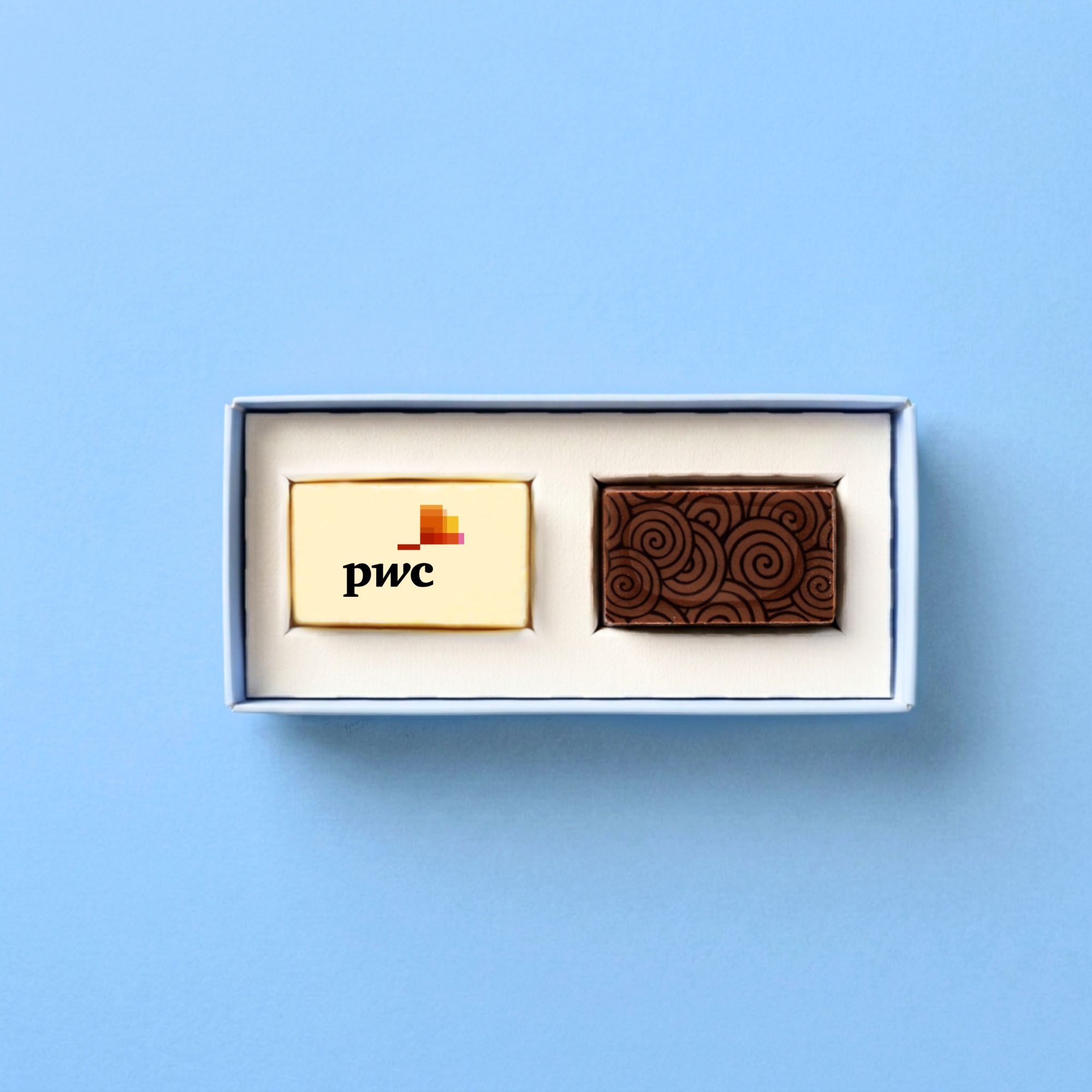 Two luxury chocolates in a box with 'pwc' branding on a light blue background