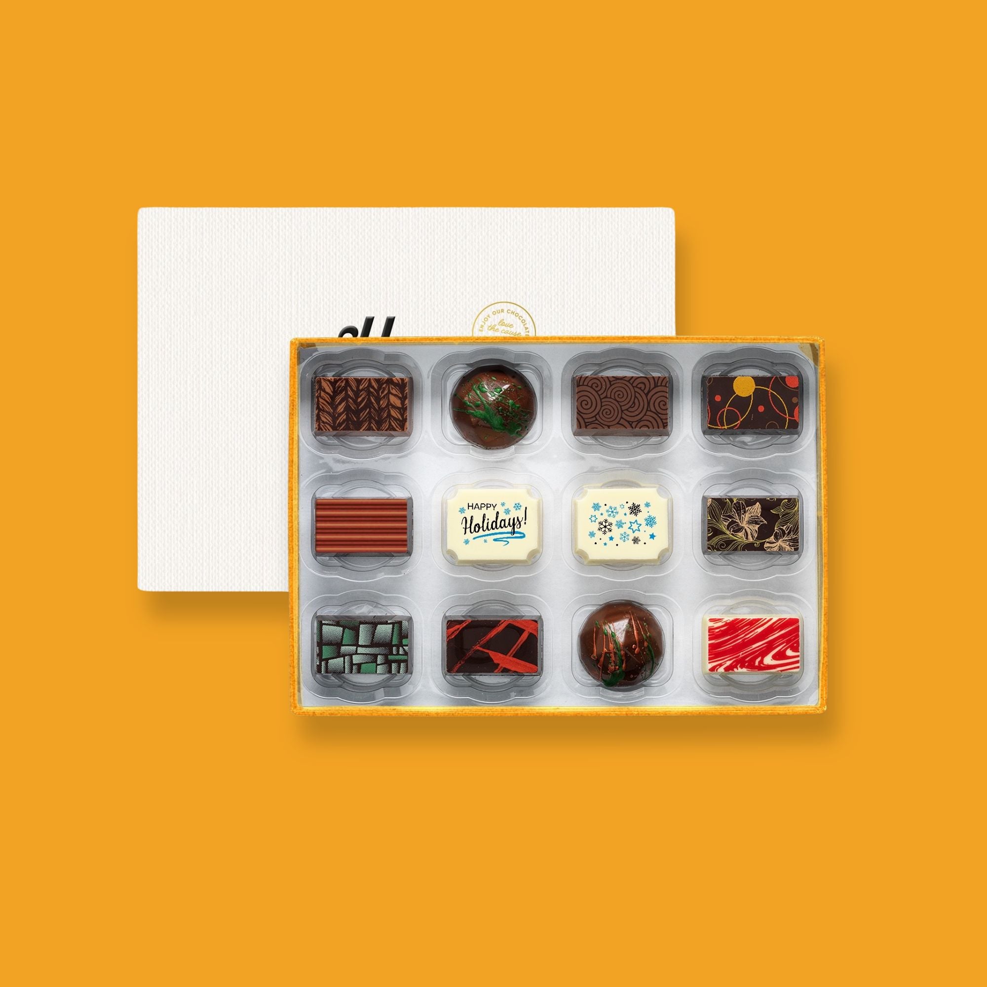 A box of 12 artisan chocolates colourfully decorated and featuring two Happy Holidays themed designs