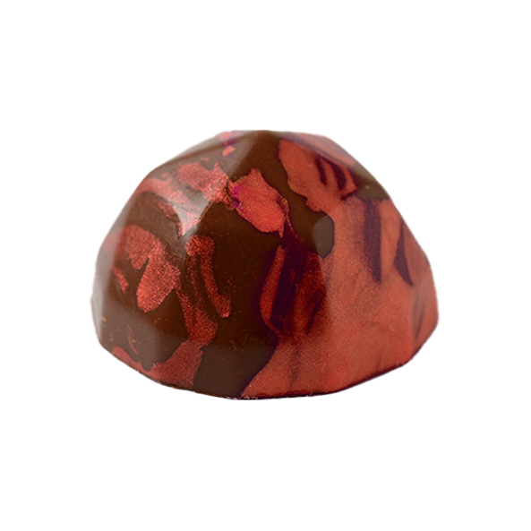 A diamond shaped dark chocolate with red cocoa butter