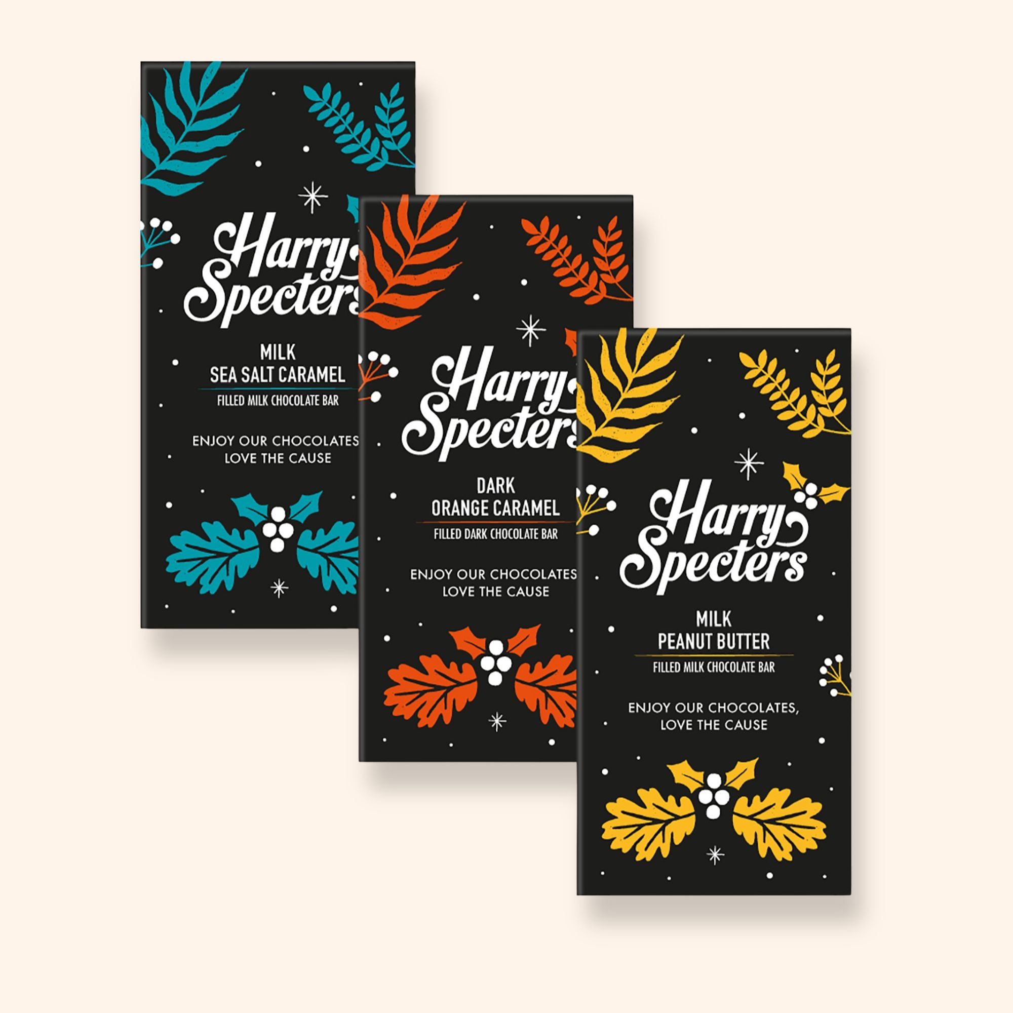 Three chocolate bars including dark vegan orange, sea salt caramel, and peanut butter flavours in festive Christmas packaging