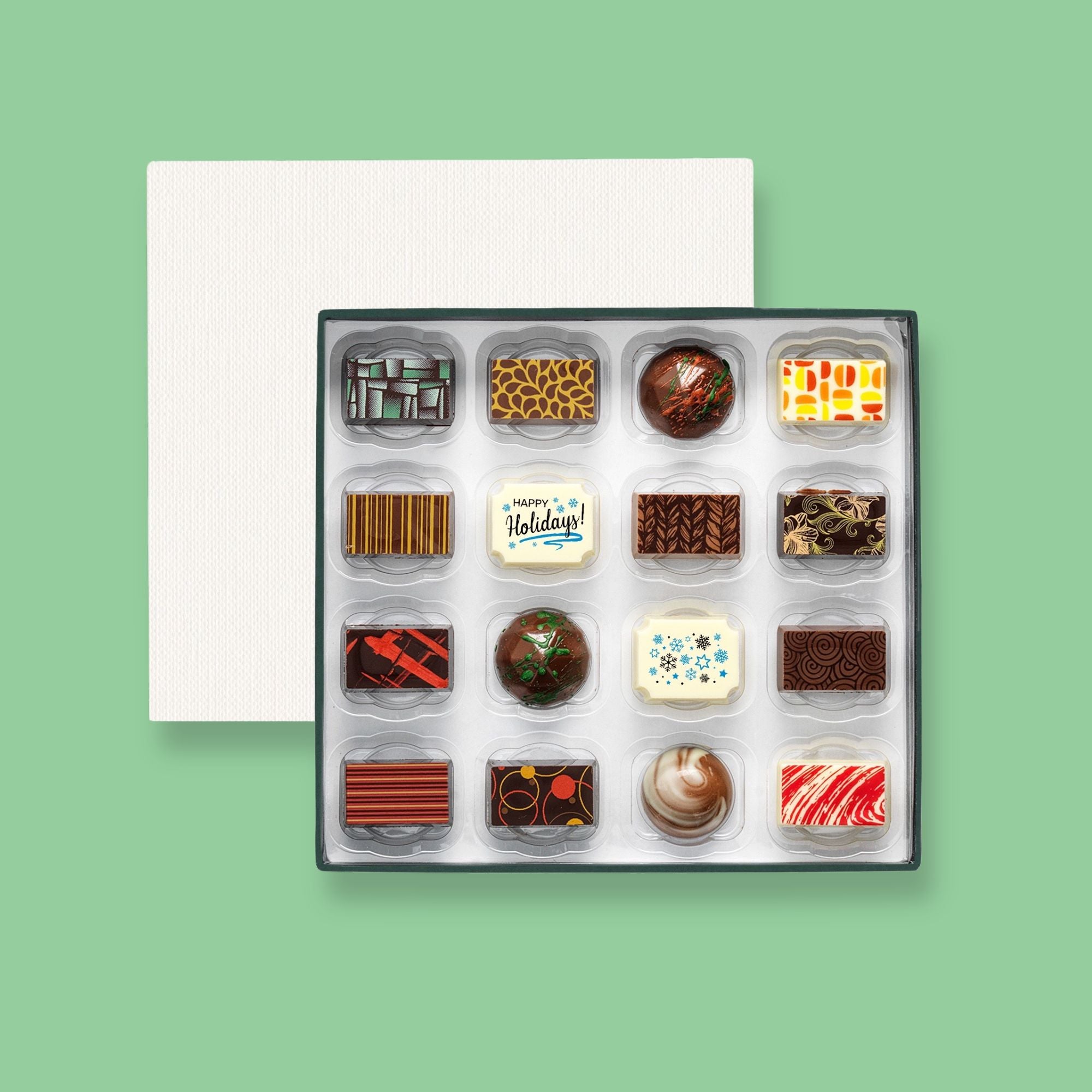 A box of 16 artisan chocolates colourfully decorated and featuring two Happy Holidays themed designs