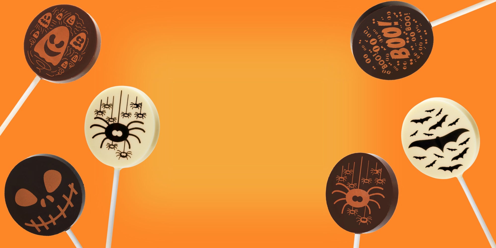 Halloween-themed chocolate lollipops with designs on an orange background