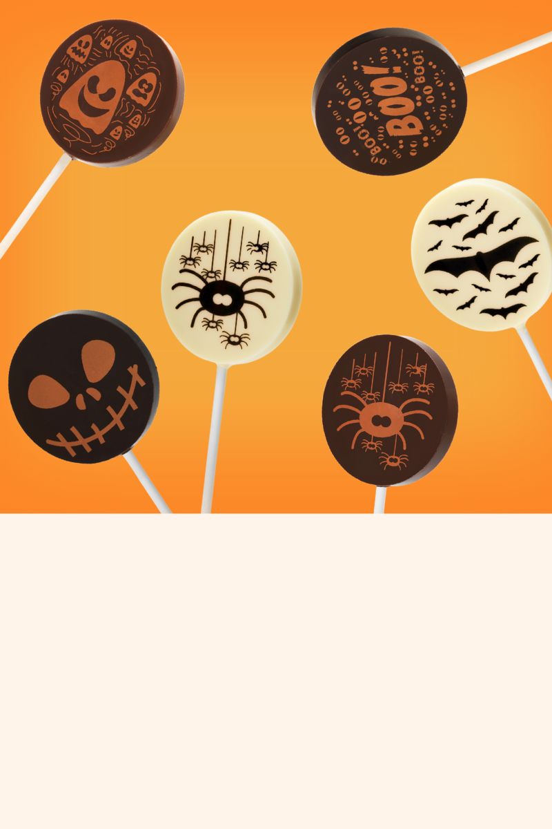 Halloween-themed chocolate lollipops on an orange background