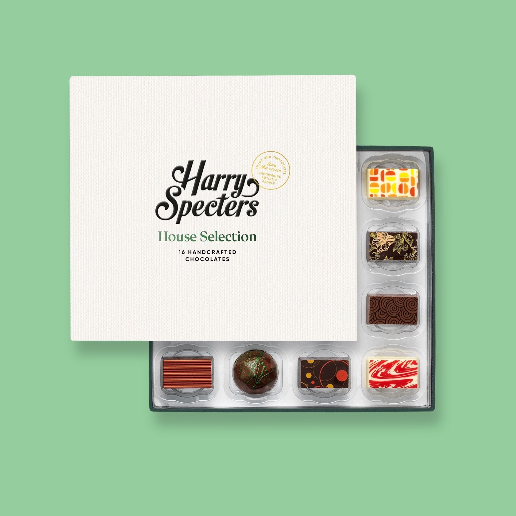 A Harry Specters subscription box of 16 colourfully decorated artisan chocolates partially covered by a lid