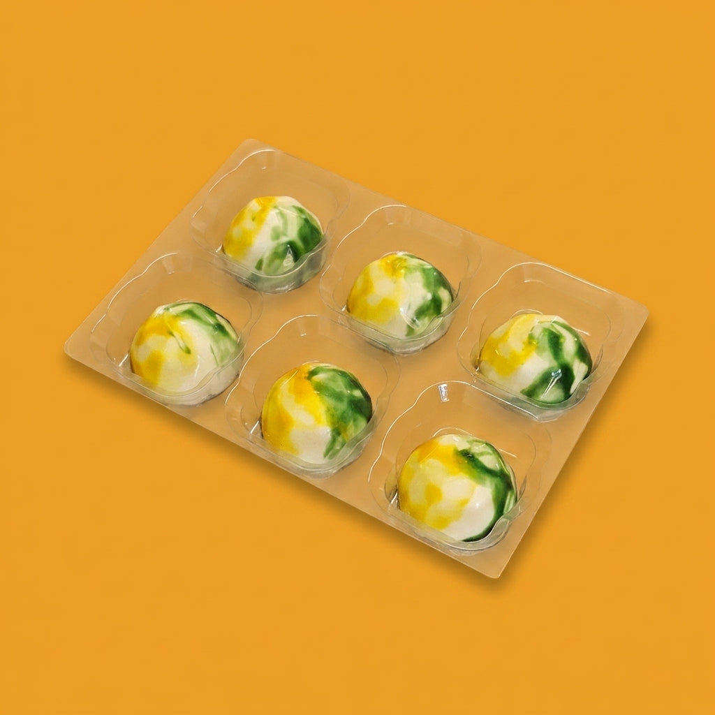 The Favourite 6 Lemon & Elderflower Chocolates — six hand-finished white chocolates in a tray.