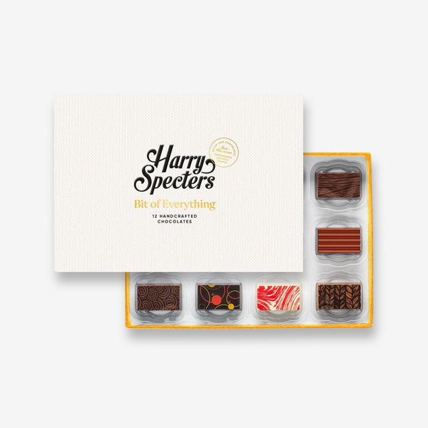 A box of 12 artisan chocolates by Harry Specters partially covered by a box lid 