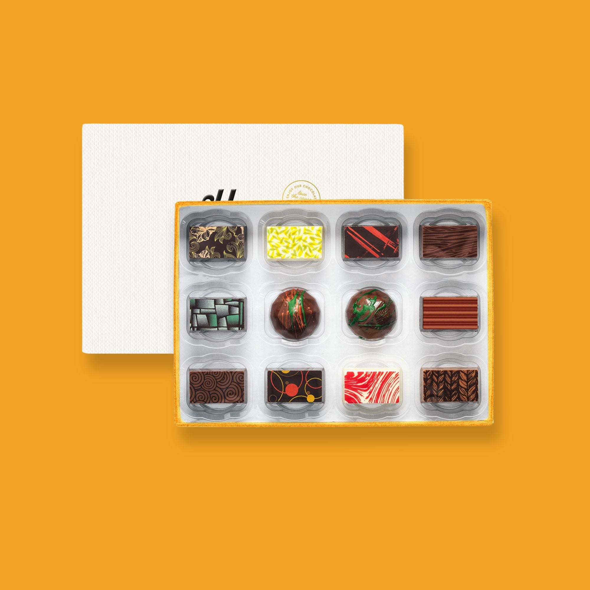 A box of 12 colourfully decorated artisan chocolates 