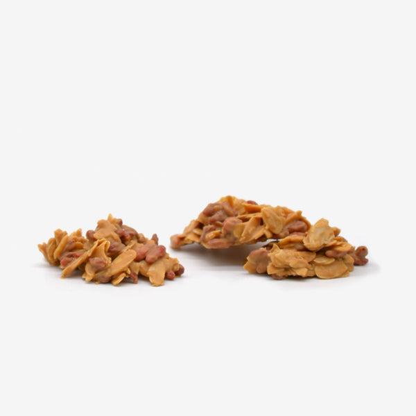 A pile of blonde chocolate clusters with almonds and goji berries