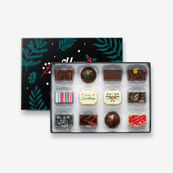 A festive box of 12 artisan chocolates colourfully decorated and featuring two Christmas themed designs