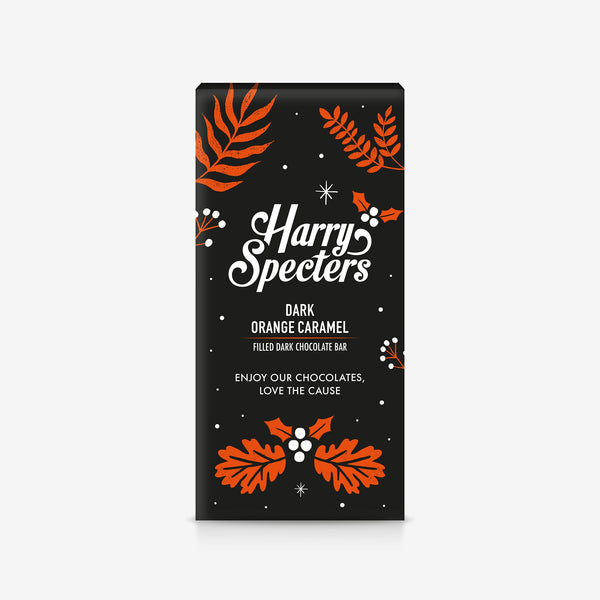 A Harry Specters dark chocolate bar filled with orange caramel in festive Christmas packaging