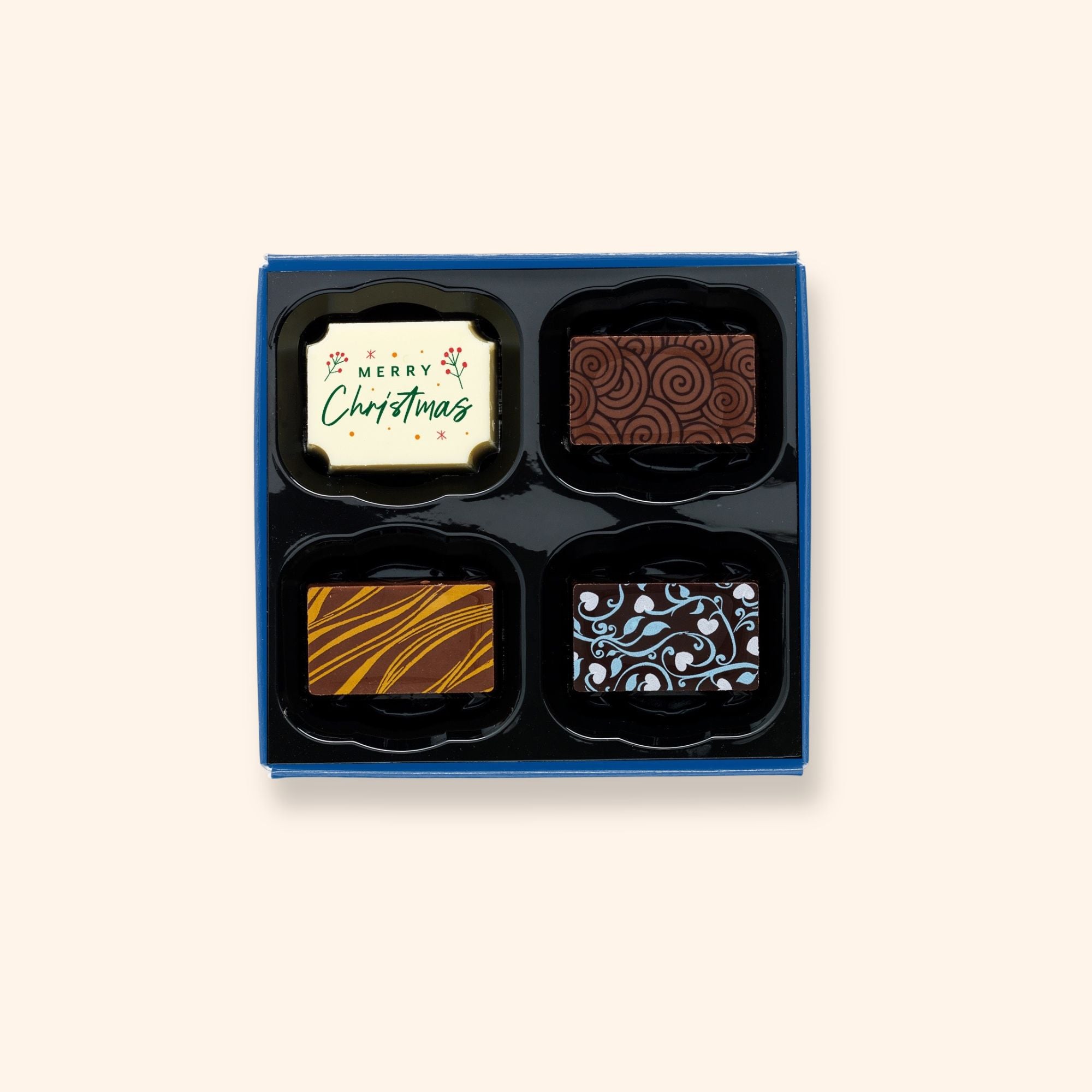 A box of 4 artisan chocolates colourfully decorated and featuring one Christmas themed design