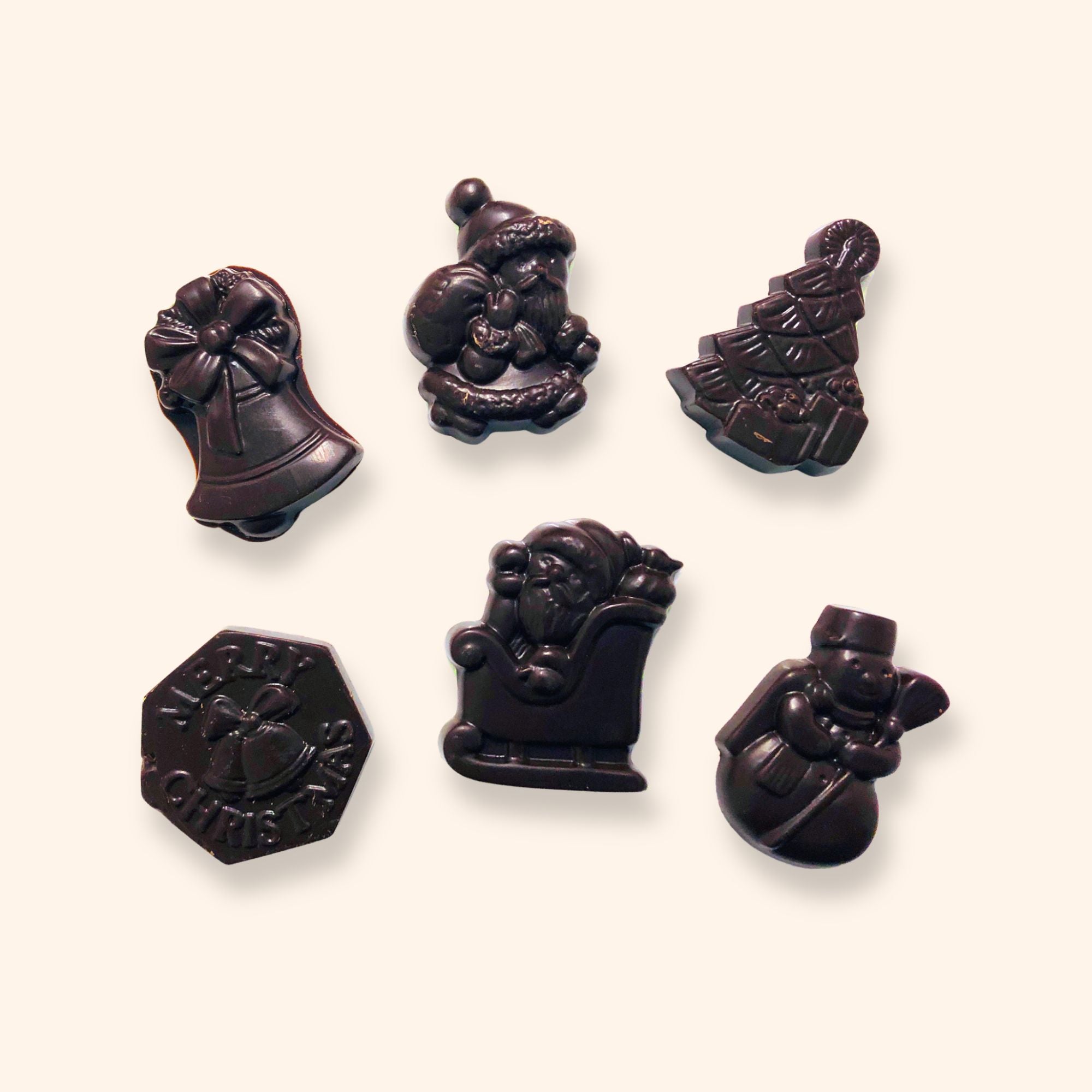 Dark chocolate Christmas shapes including designs showing snowmen, Christmas trees, and Santa Claus