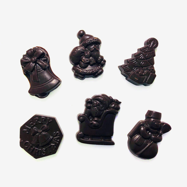 Dark chocolate Christmas shapes including designs showing snowmen, Christmas trees, and Santa Claus