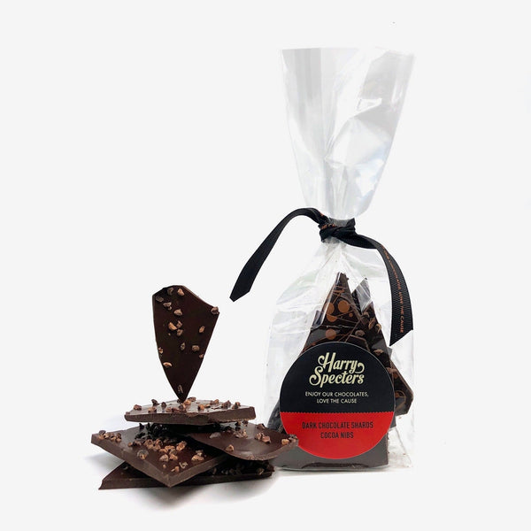 A bag of vegan dark chocolate shards decorated with roasted cocoa nibs