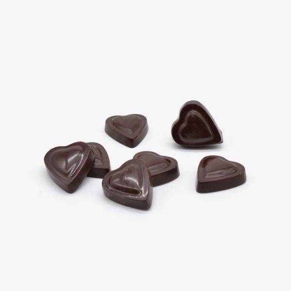A pile of vegan dark chocolate heart shapes for Valentine's Day