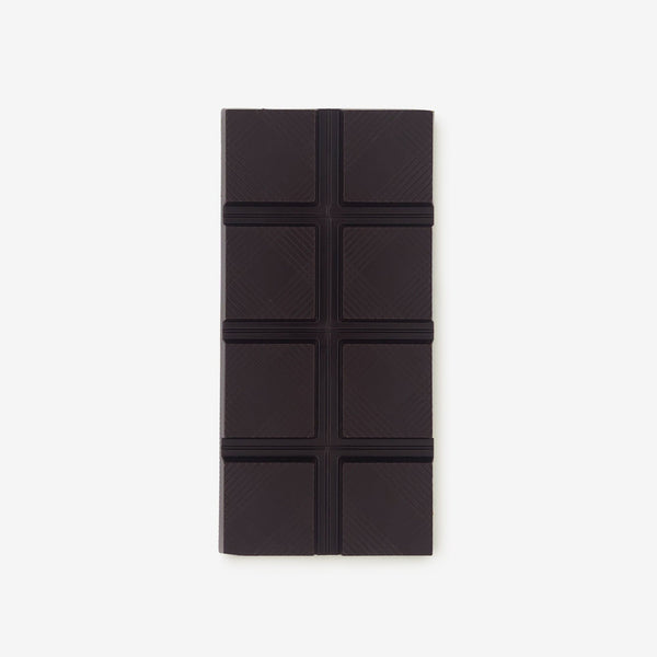 The front of a vegan dark chocolate bar by Harry Specters decorated with roasted cocoa nibs