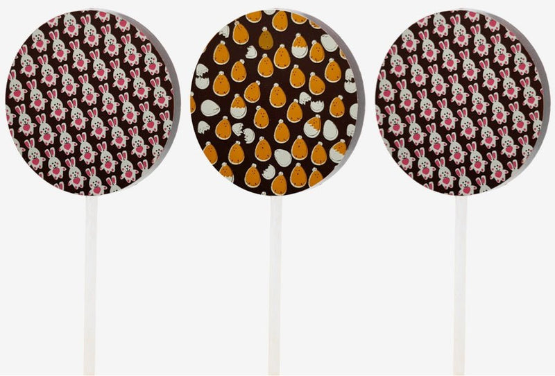 Three dark chocolate lollipops featuring designs of chicks and Easter bunnies