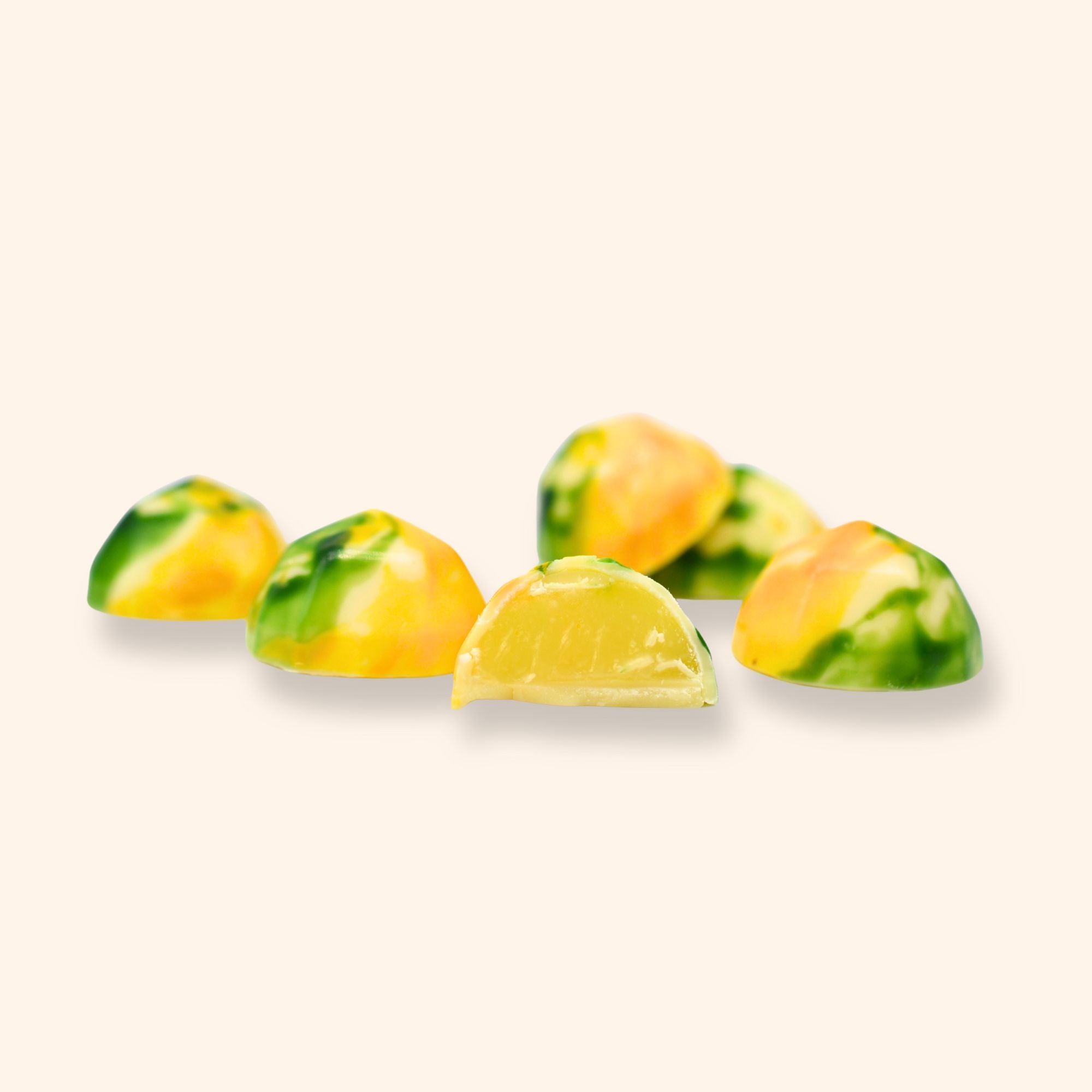 Colourful lemon elderflower chocolates on a light beige background
