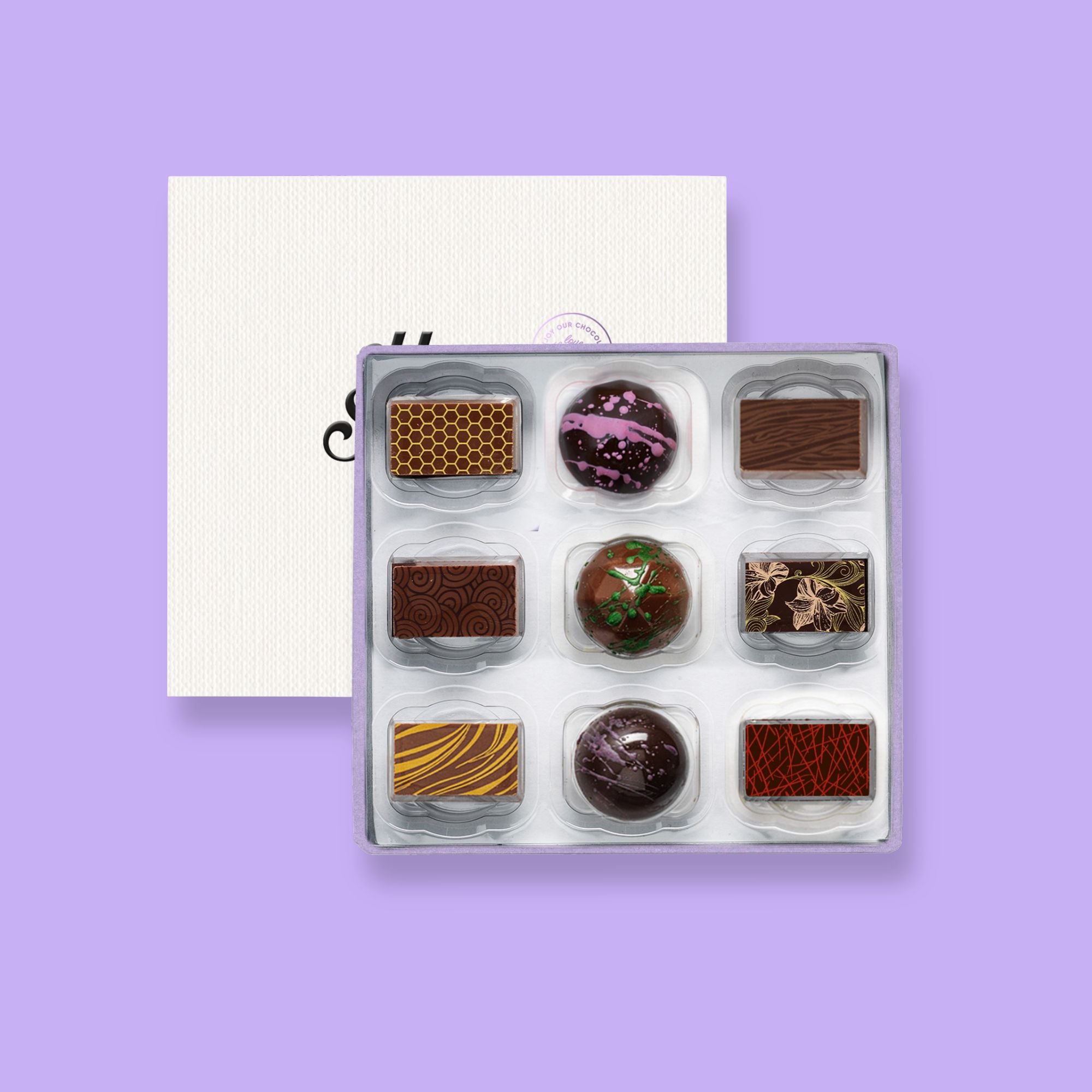 A box of 9 artisan chocolates colourfully decorated 