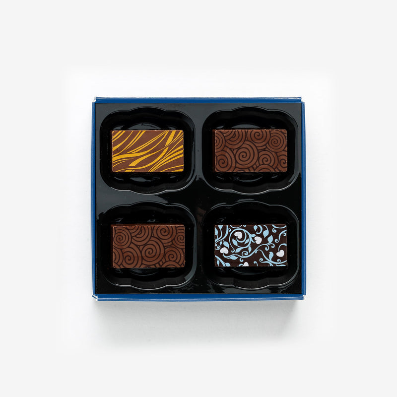 A box of 4 artisan chocolates colourfully decorated