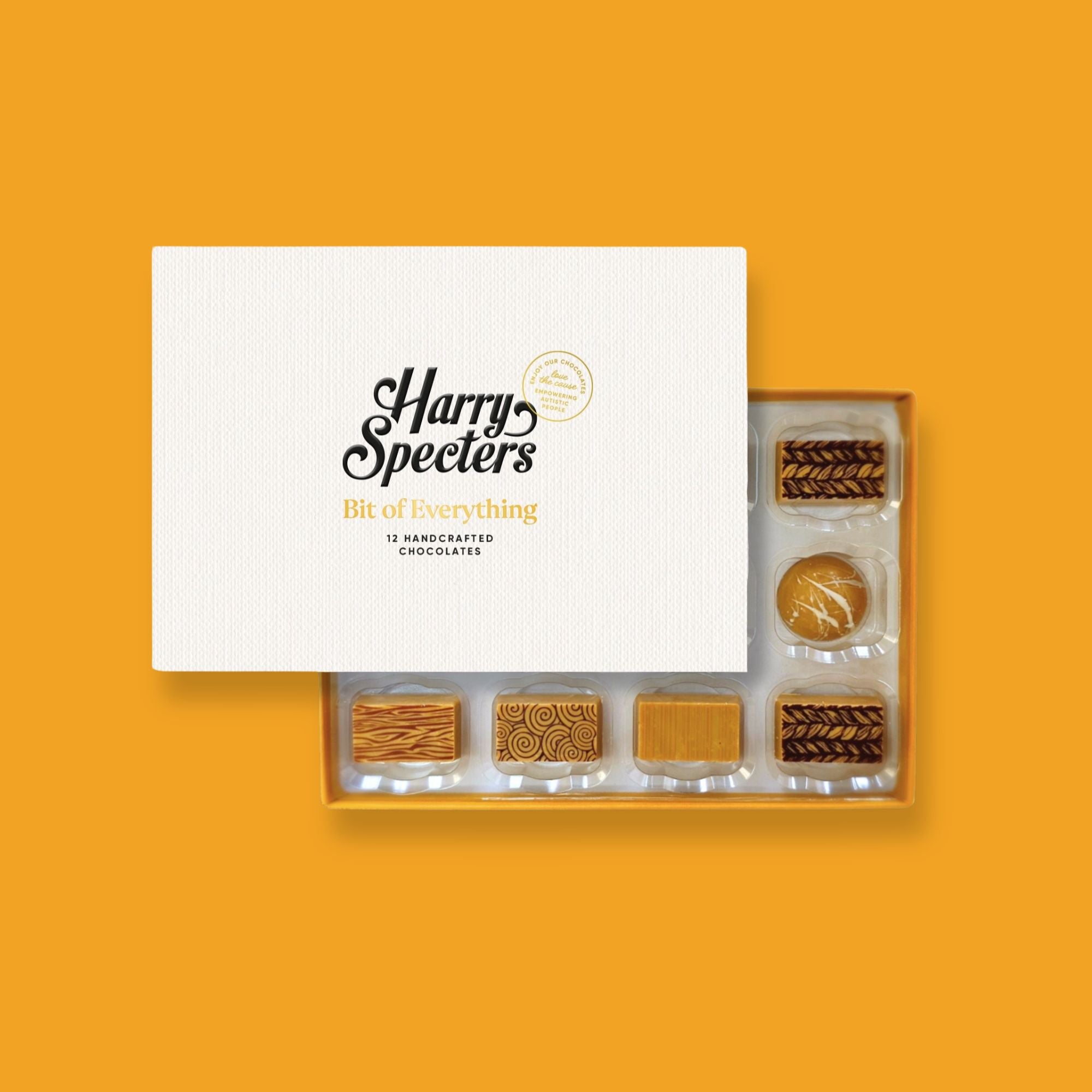 A box of 12 artisan blonde chocolates by Harry Specters partially covered by a box lid 