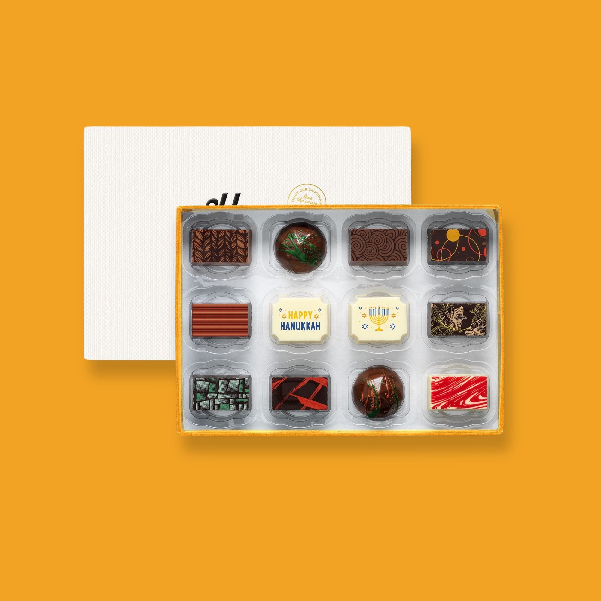 A box of 12 artisan chocolates colourfully decorated and featuring two Hanukkah themed designs