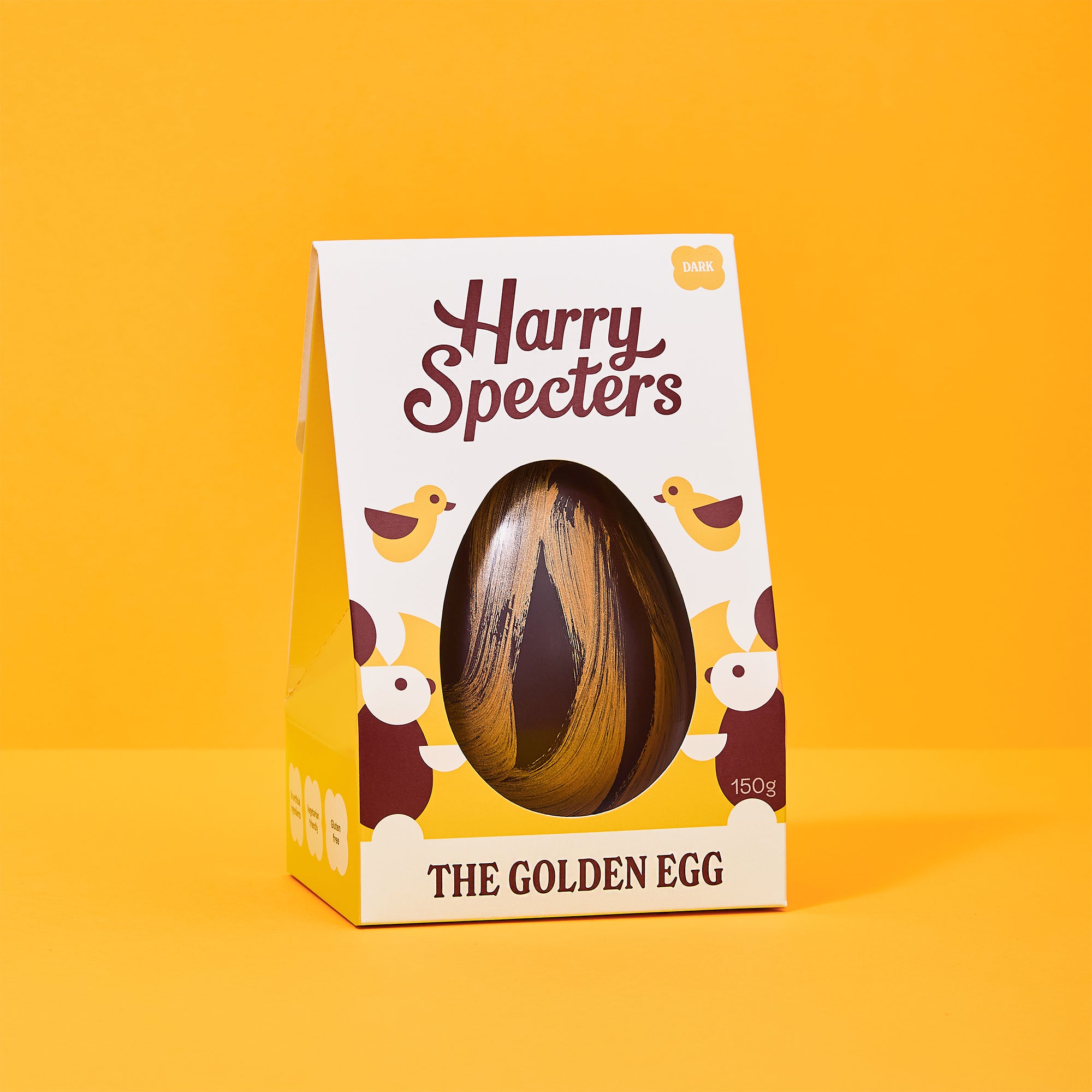 Golden dark chocolate Easter Egg in colourful packaging