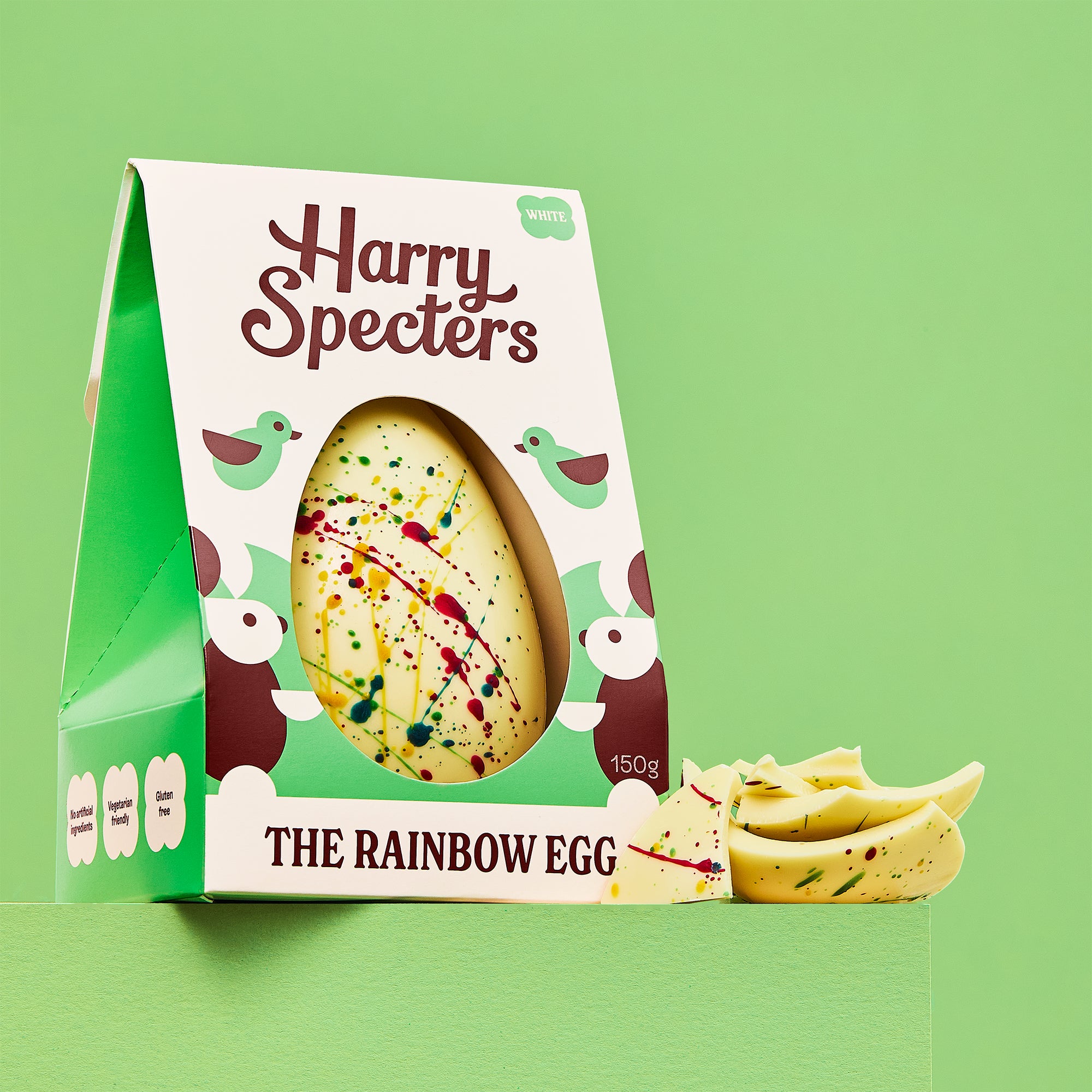 The Rainbow Egg is a white chocolate luxury Easter egg shown on a green background