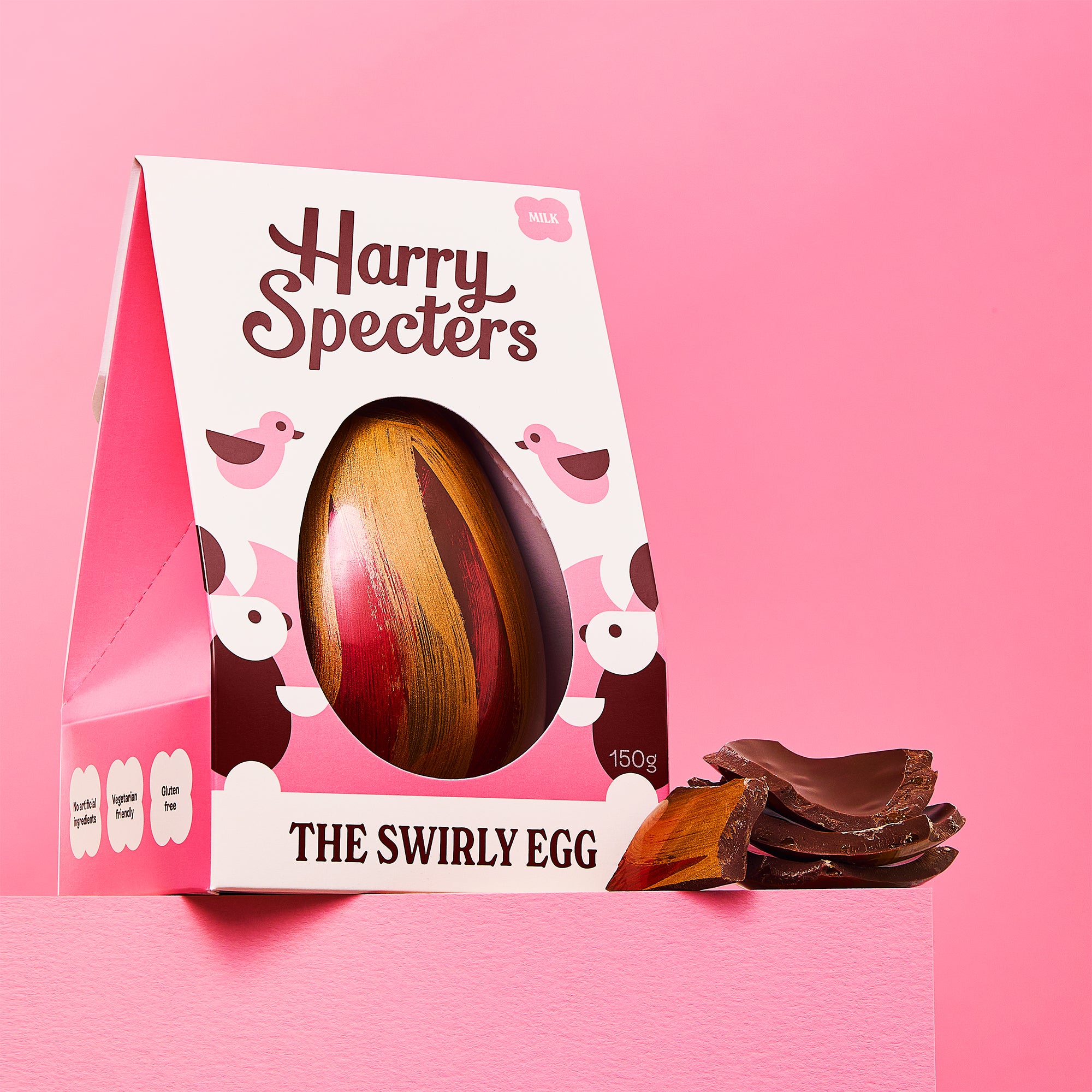 The Swirly Egg is a milk chocolate luxury Easter egg shown on a pink background