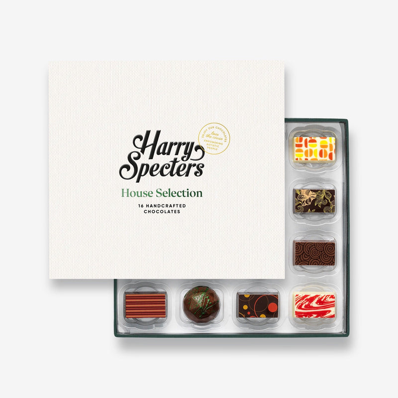 A box of 16 artisan chocolates partially covered by a box lid featuring the name Harry Specters