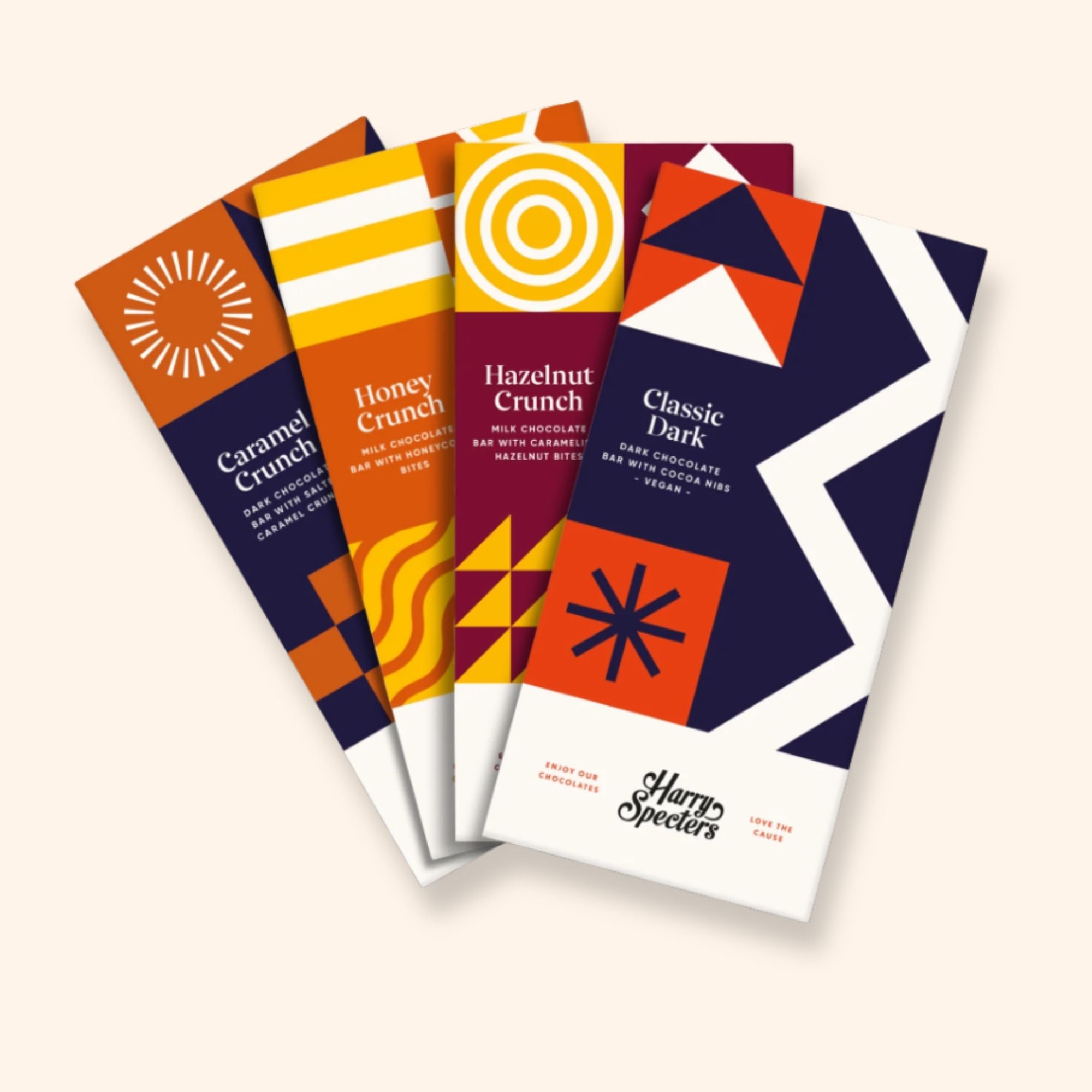 Four dark and milk chocolate bars in different flavours including honeycomb, hazelnut, caramel crunch, and dark chocolate
