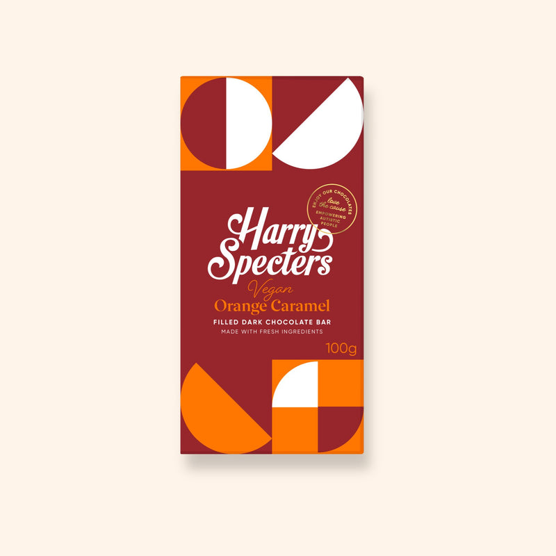 A dark vegan chocolate bar filled with orange caramel in colourful packaging showing the name Harry Specters
